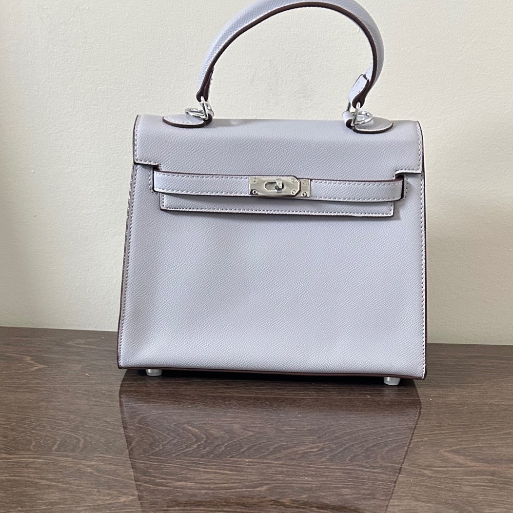 Small purple satchel bag with decorative strap and mini padlock
